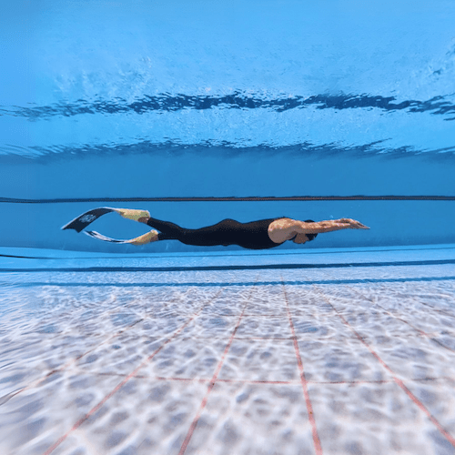 underwater view of freediver dive using bifins